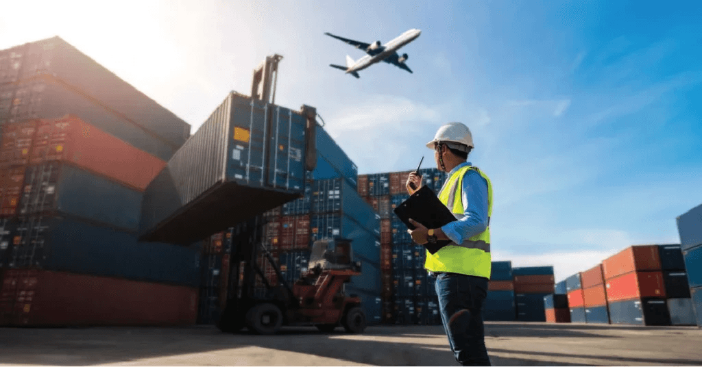 Logistics worker with a clipboard at a container port as a plane flies overhead