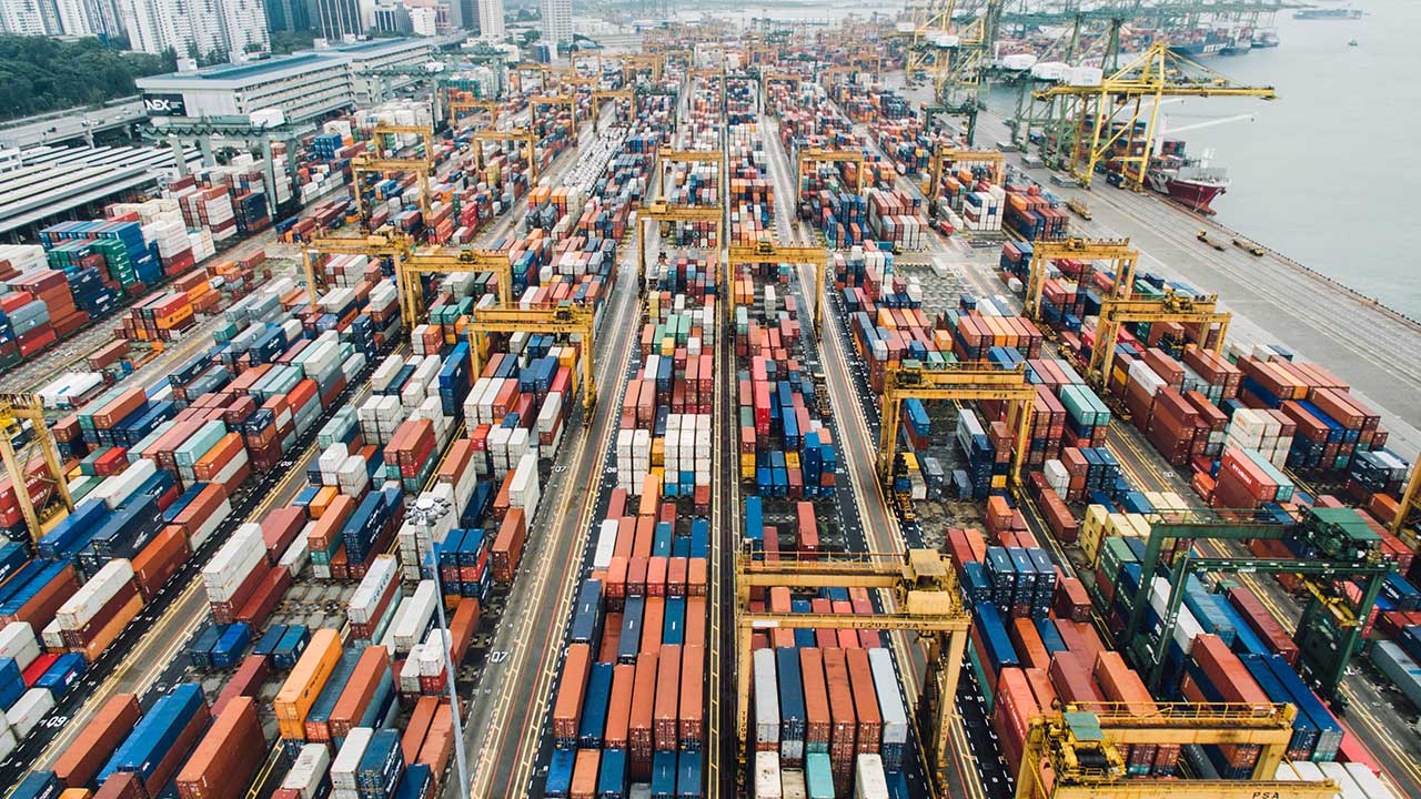 Aerial view of a container port stacked with shipping containers